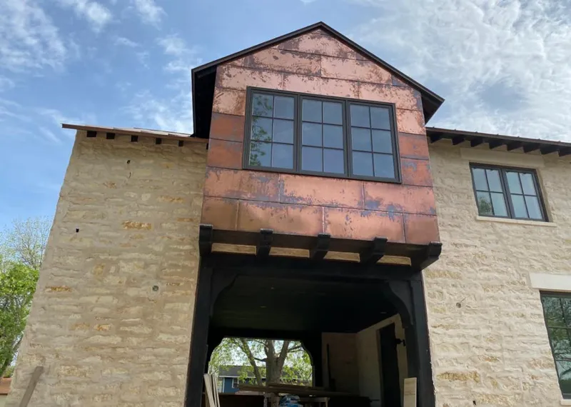 Copper metal panel facade on a stone building for Skylight Installation in Elmhurst